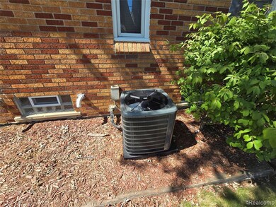 Exterior view of brick siding and a cooling unit