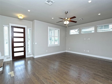 Entryway featuring dark wood-style flooring, ceiling fan, and recessed lighting