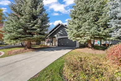 Obstructed view of property featuring driveway and an attached garage