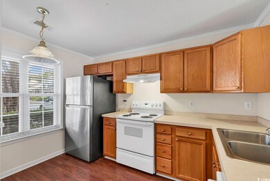 Kitchen featuring hanging light fixtures, stainles