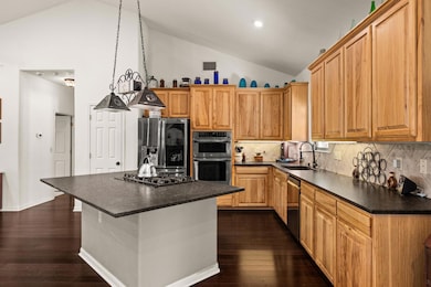 Kitchen featuring dark countertops, a breakfast b