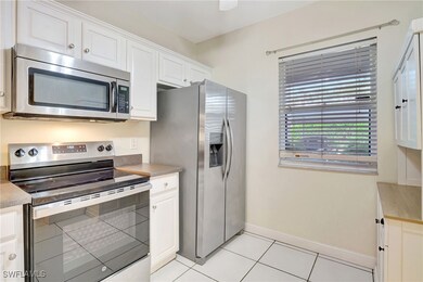 Kitchen with baseboards, light tile patterned floo