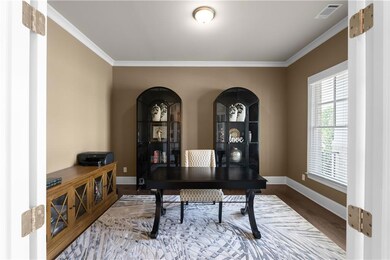 Home office featuring visible vents, wood finished