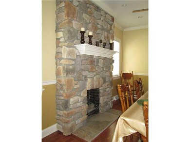Other. Stone gas fireplace with wooden mantle and 