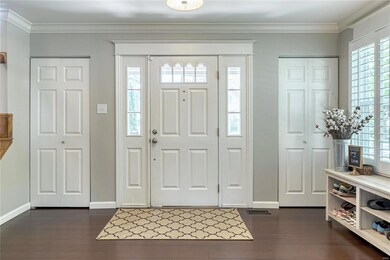 The spacious foyer with closets on either side of 