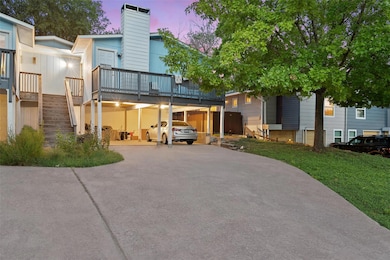 View of front facade with a chimney, driveway, st