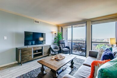 The living room offers a wall of windows providing