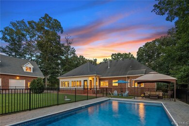 Pool at dusk featuring a yard, a gazebo, and an ou