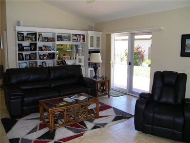 portion of living room with display and storage un