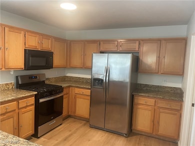 Kitchen featuring stainless steel appliances, ligh