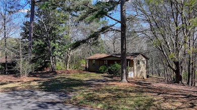 View of front of home featuring a wooded view