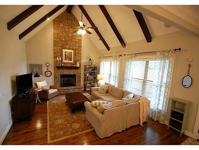 Living Room. Living area with soaring ceilings, wood beam accents, amazing hardwoods and a stunning fireplace!