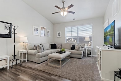 Living area with vaulted ceiling and ceiling fan