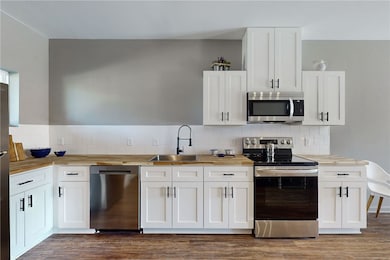 Kitchen featuring stainless steel appliances, a si