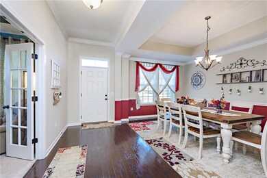Foyer and formal dining room with durable hardwood floors. 