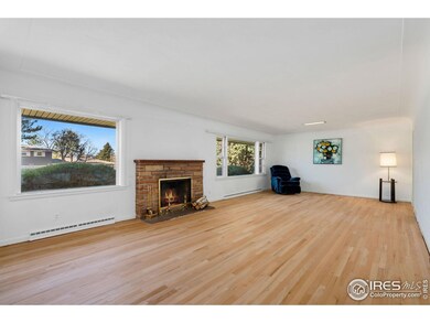 Generous living room drenched in natural light, features a cozy wood burning fireplace.