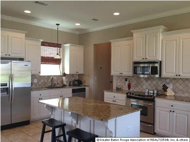 Custom Built Kitchen with Slab Granite, Travertine