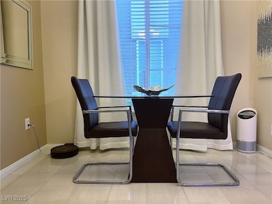Tiled dining space featuring baseboards