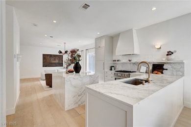 Kitchen with wall chimney range hood, stainless st