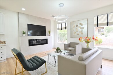 Living area with a fireplace, recessed lighting, l