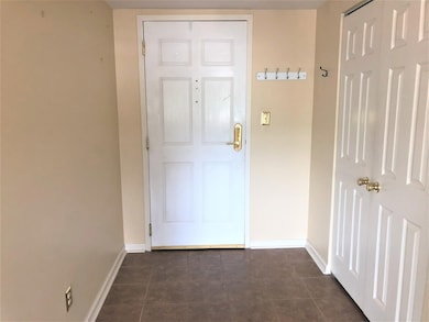 Foyer with double door coat closet