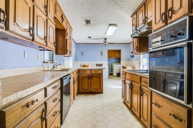 Kitchen featuring ceiling fan, sink, washer / drye