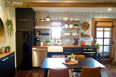 Kitchen featuring open shelves, dark wood-style fl