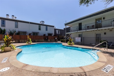 Community pool with a patio, a balcony, and stairway