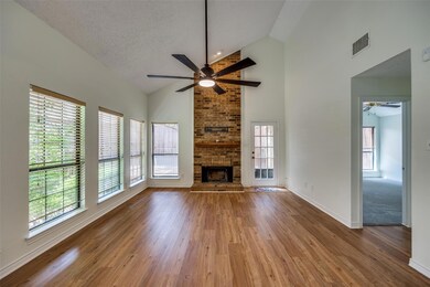 Unfurnished living room featuring a textured ceili