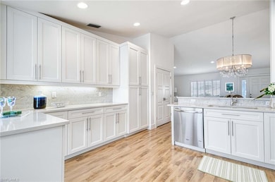 Kitchen featuring pendant lighting, sink, white ca