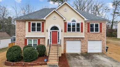 Raised ranch with a garage, brick siding, a shingl