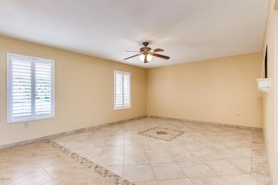 Living Room, Foyer, and Coat Closet with Plantation Shutters, shelve, ceiling fan, and tile floors!