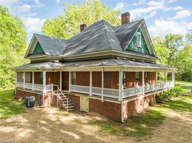Rear side view. Full wraparound porch.