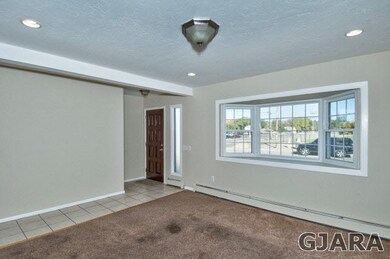 The formal living room has a bayed viewing window.