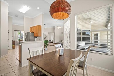 Dining room with a ceiling fan, light tile patterned floors, ornamental molding, baseboards, and recessed lighting