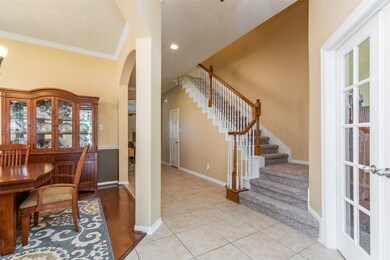 Upon entering the home you are greeted with tile floors and a view of the formal dining room.
