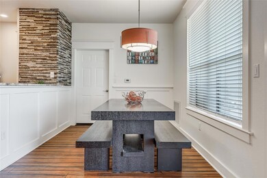 Dining space with a wainscoted wall, dark wood-st