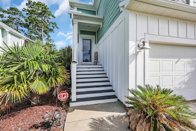 Property entrance with board and batten siding and an attached garage