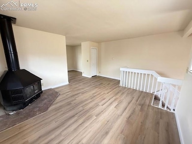 Unfurnished living room featuring wood finished fl