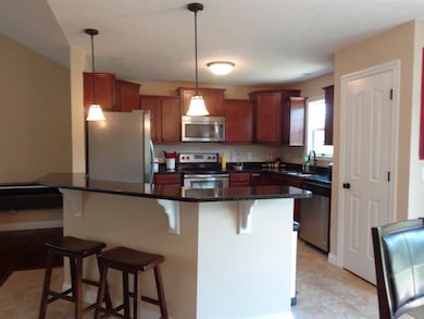 The kitchen offers a breakfast bar, granite counte