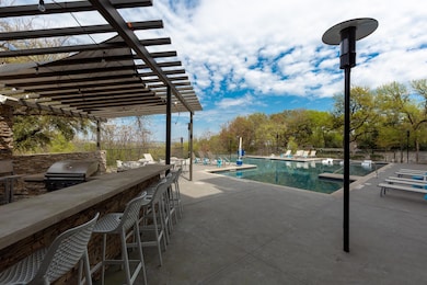 Community pool featuring a pergola and a patio ar
