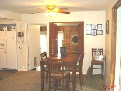 A roomy dining area convenient to kitchen, den, an