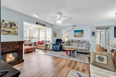 Living area with visible vents, wood finished floo