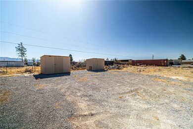 View of yard featuring an outbuilding and a shed