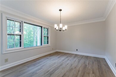 Empty room with a chandelier, baseboards, ornament