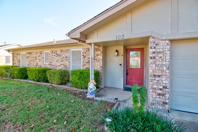Property entrance with brick siding and a garage