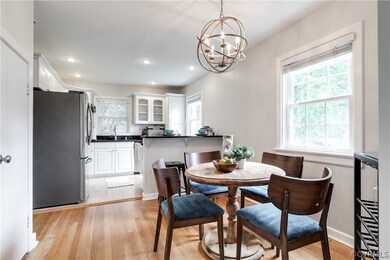Tiled dining room featuring sink and a chandelier