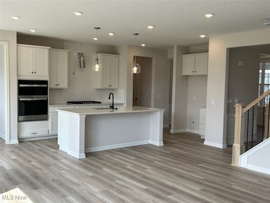 Open concept living space with the kitchen island overlooking the gathering room.