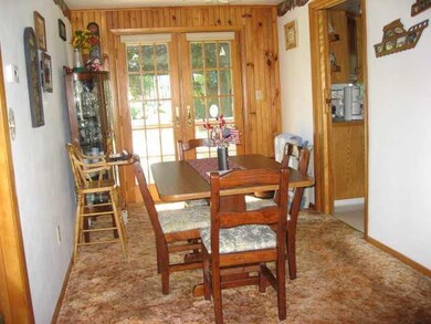 Dining Room. Stylish French Doors and knotty pine 