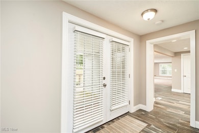 Doorway to outside featuring french doors and wood finished floors